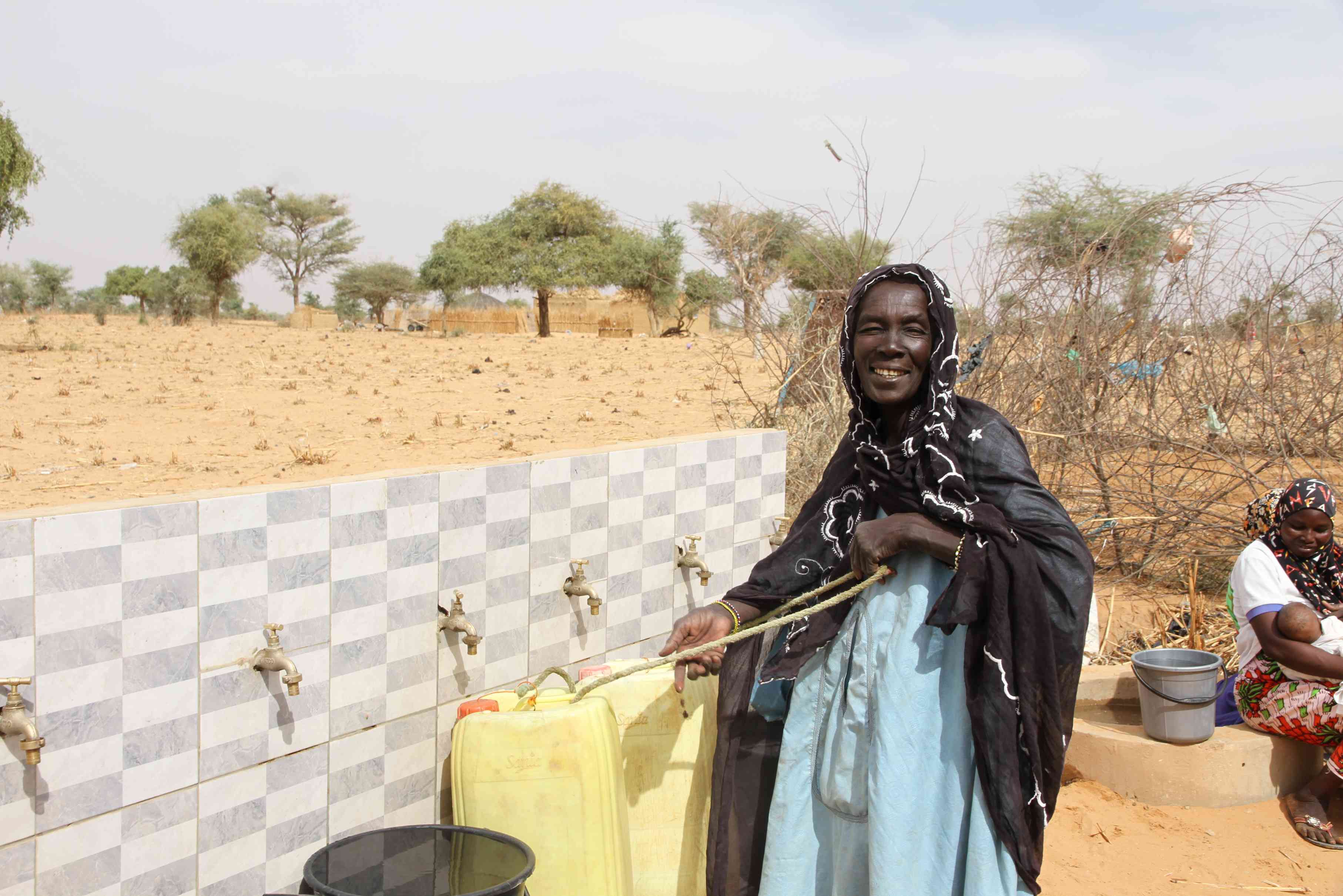 People gathering around a medium community well